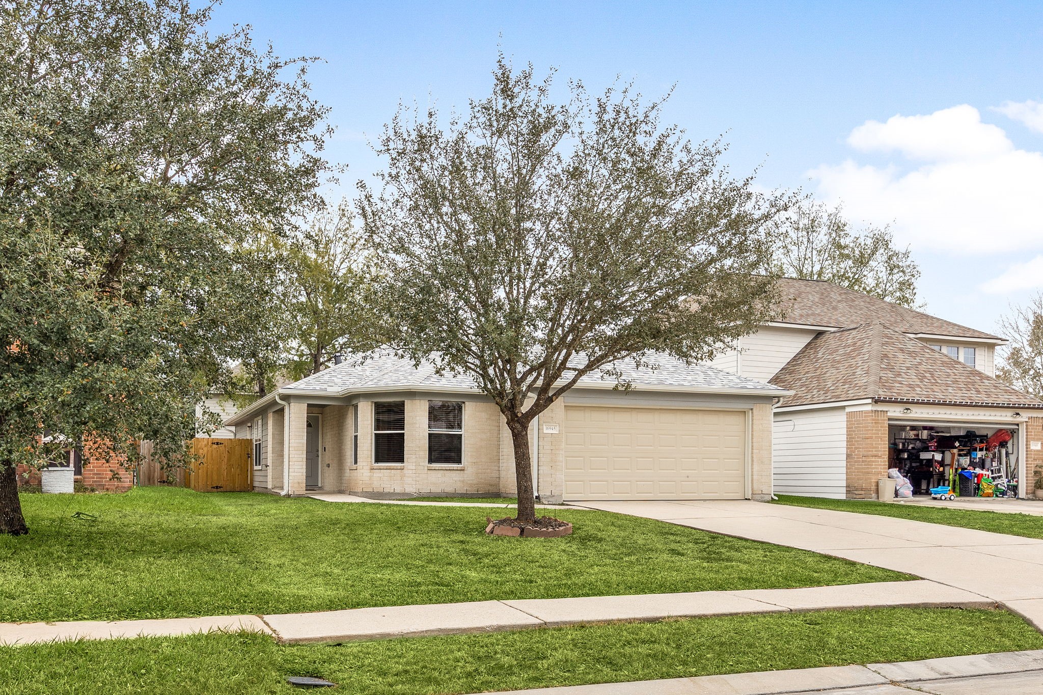 16945 Scenic Knoll Conroe, TX 77385 - Photo 5 of 39 a front view of a house with a garden