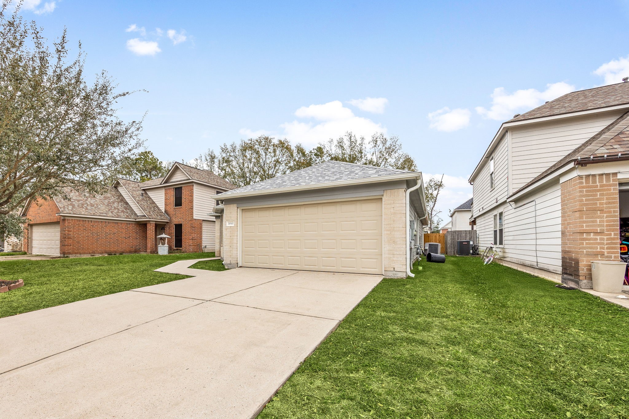 16945 Scenic Knoll Conroe, TX 77385 - Photo 6 of 39 a view of a house with a yard and garage