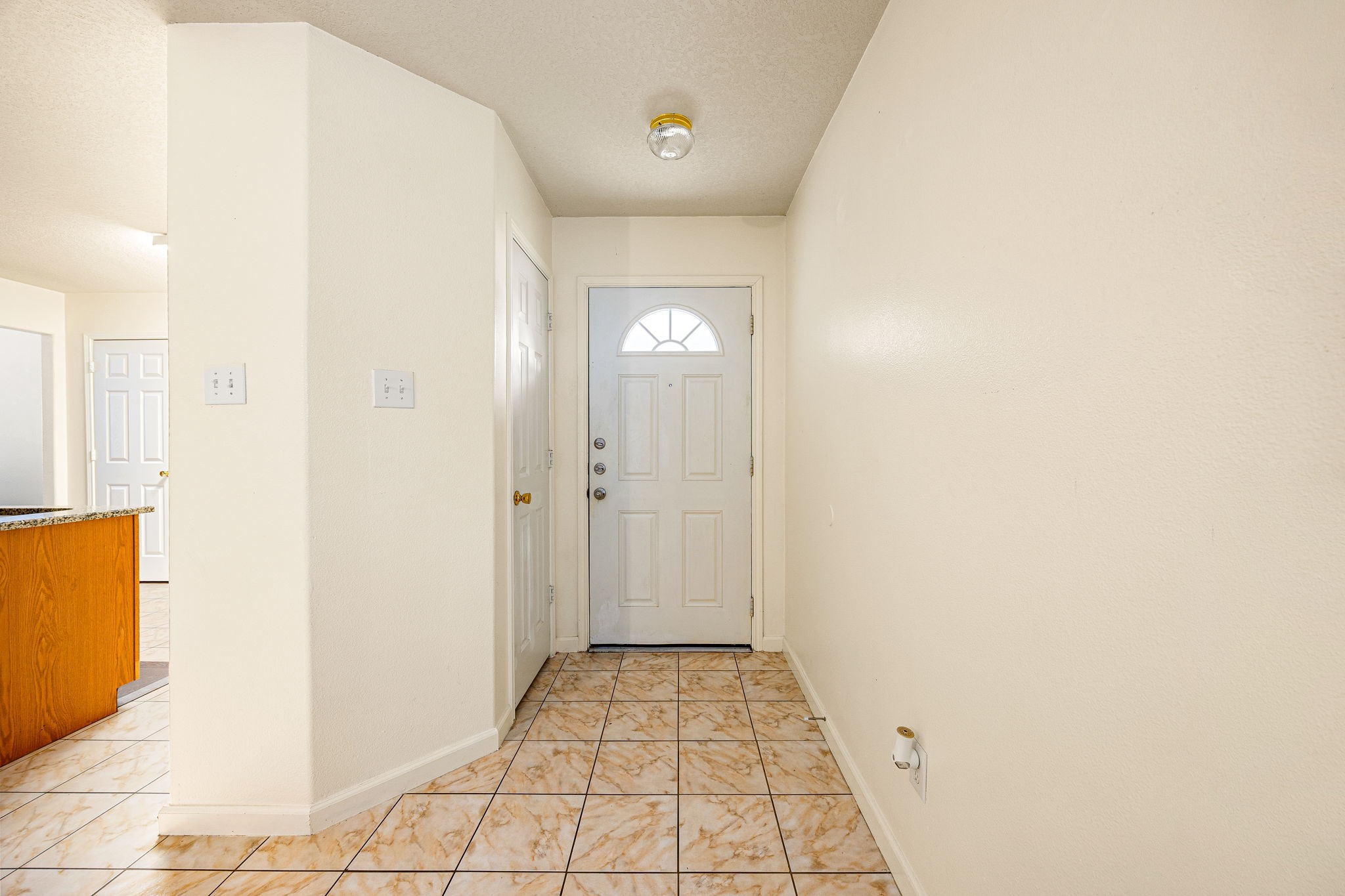 16945 Scenic Knoll Conroe, TX 77385 - Photo 9 of 39 a view of a hallway with wooden floor and a bathroom