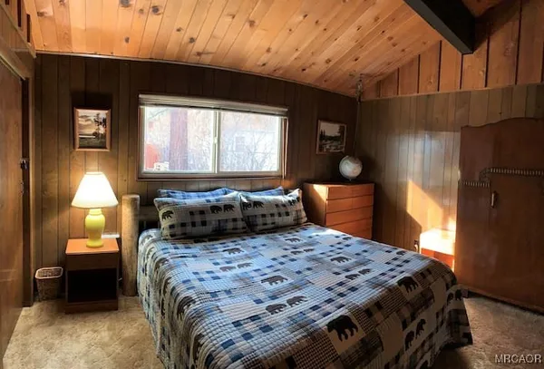 a bedroom with a bed and window