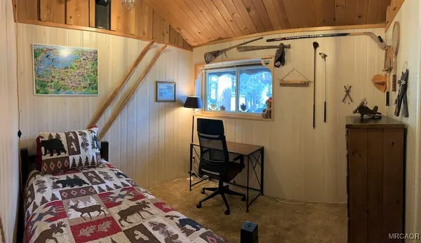 a bed sitting in a bedroom next to a window