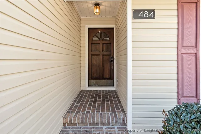 a view of a door and brick walls
