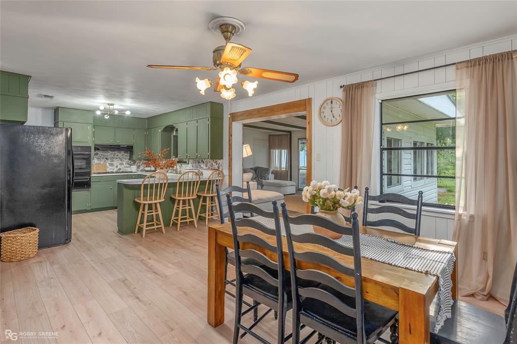 a view of a dining room with furniture and a chandelier