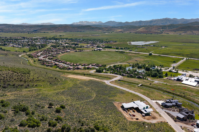 910 Wasatch Drive Kamas, UT 84036 - Photo 18 of 36 Expansive aerial perspective showcasing a residential development nestled within a verdant valley, framed by distant mountains