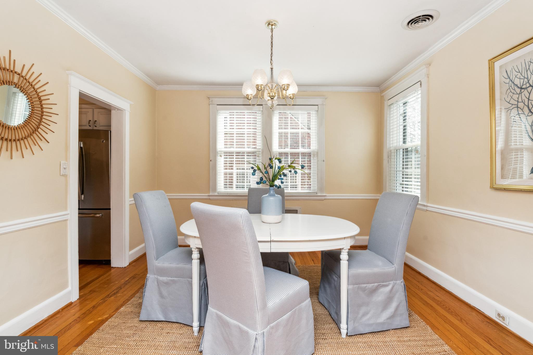 716 Anneslie Road Baltimore, MD 21212 - Photo 6 of 27 a dining room with furniture a chandelier and wooden floor