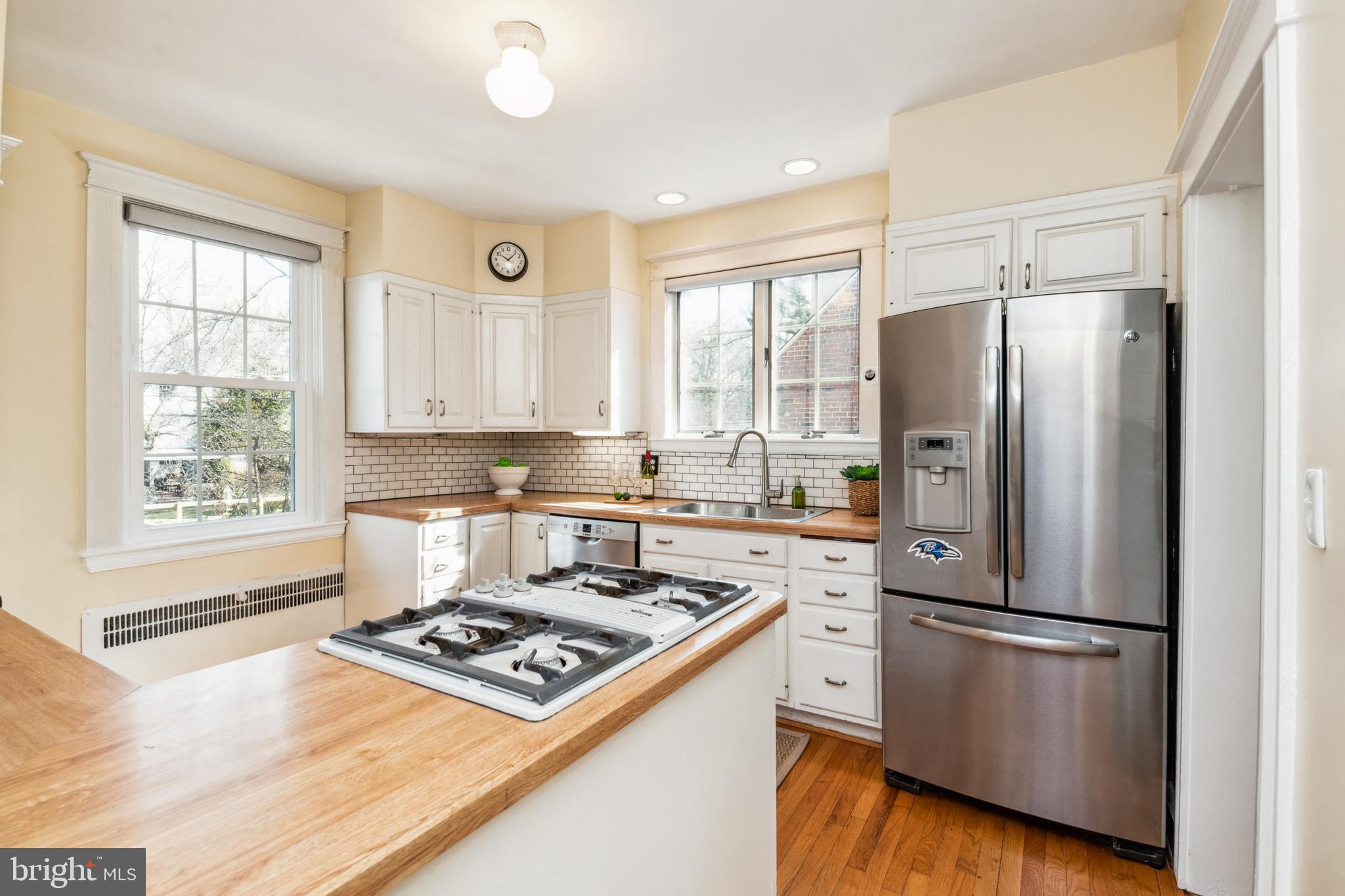 716 Anneslie Road Baltimore, MD 21212 - Photo 8 of 27 a kitchen with a refrigerator a stove a sink and a window