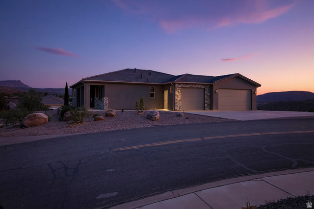217 West Terrace Circle Toquerville, UT 84774 - Photo 2 of 25 Ranch-style house with stone siding, a garage, concrete driveway, and stucco siding