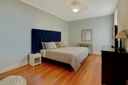 a bedroom with bed and wooden floor