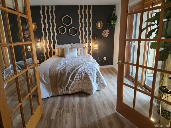 a bedroom with a bed and a mirror