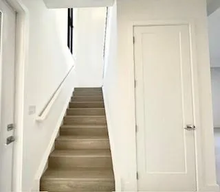 a view of staircase with white walls