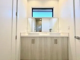 a bathroom with a granite countertop sink a mirror and a window