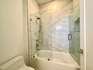 a bathroom with a bathtub and a toilet