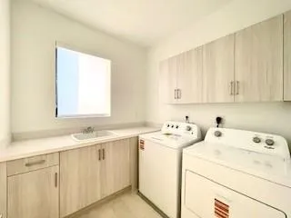a view of a storage and utility room with a washer dryer