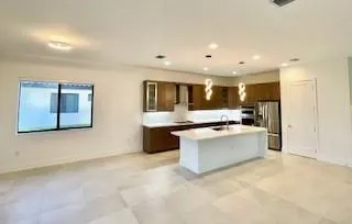 a large kitchen with kitchen island a sink stainless steel appliances and cabinets