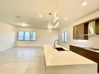 a large white kitchen with a large window