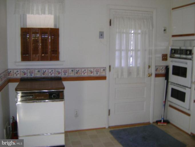 9823 Forge Park Road Perry Hall, MD 21128 - Photo 8 of 14 a kitchen with a refrigerator and a stove top oven