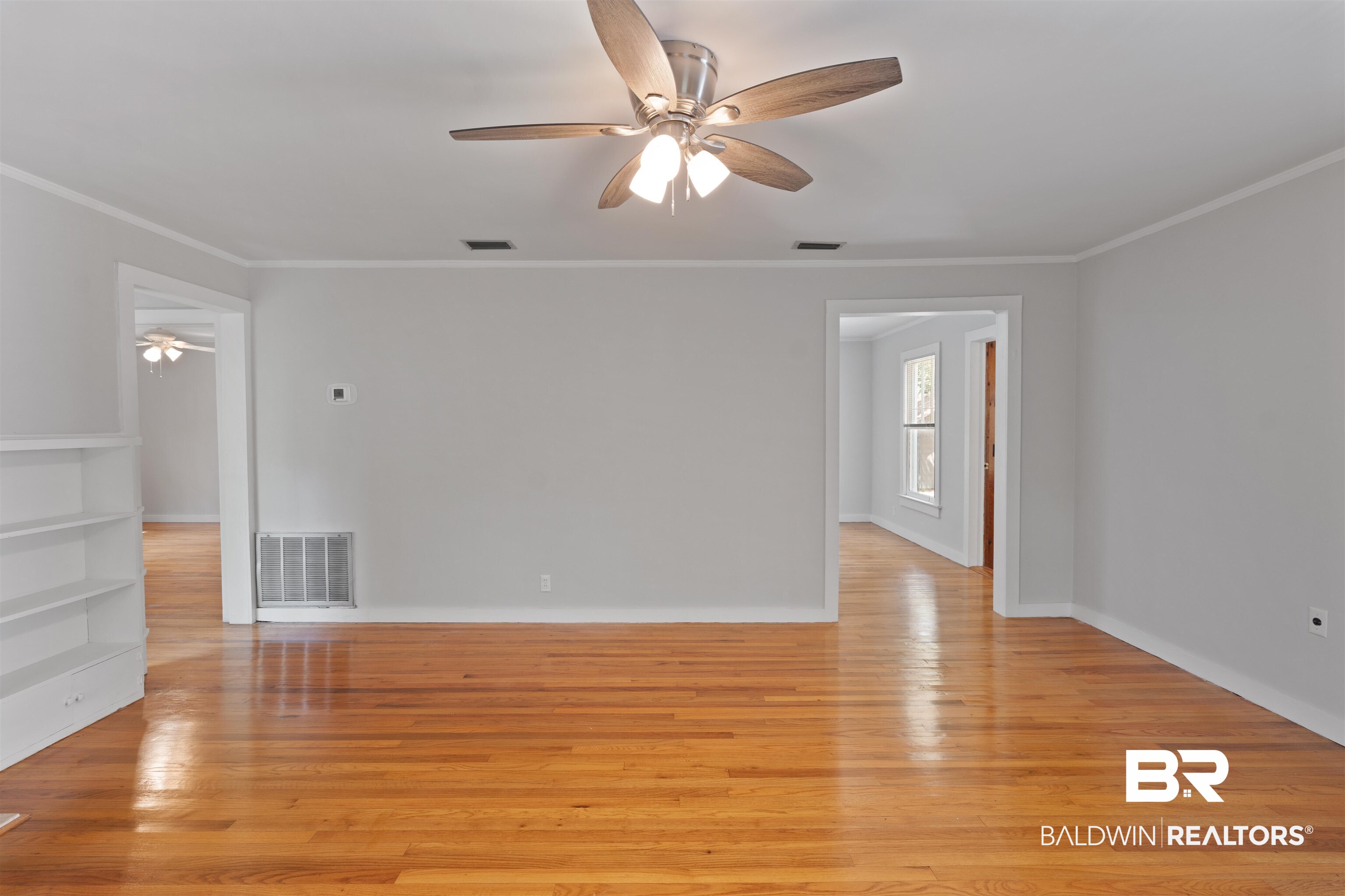 2126 Barron Place Mobile, AL 36605 - Photo 8 of 33 Unfurnished room featuring ceiling fan, crown molding, and light hardwood / wood-style floors