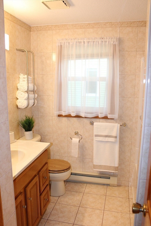 28 State Street Chicopee, MA 01013 - Photo 20 of 25 a bathroom with a granite countertop sink a toilet and a mirror