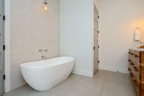 a white toilet sitting next to a bath tub and a shower