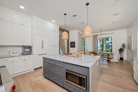 a bathroom with a granite countertop toilet sink and mirror