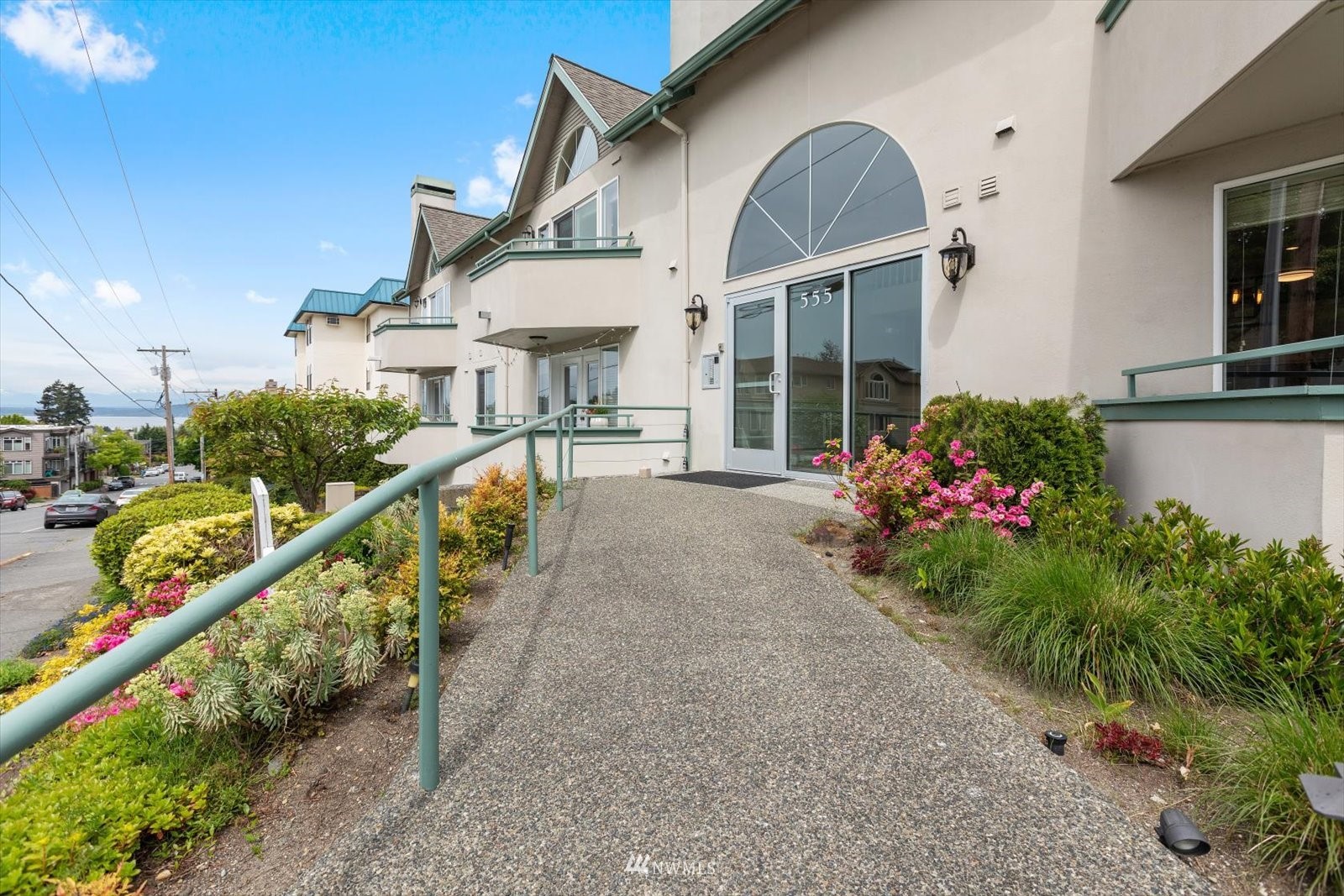 555 Walnut Street, Unit 4 Edmonds, WA 98020 - Photo 15 of 16 a view of a house with large windows and flower plants
