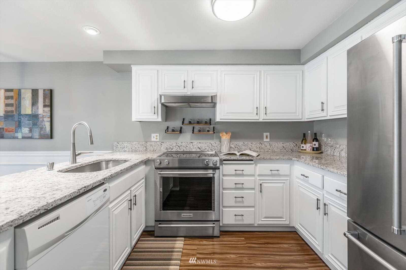 555 Walnut Street, Unit 4 Edmonds, WA 98020 - Photo 7 of 16 a kitchen with stainless steel appliances granite countertop a stove sink and cabinets