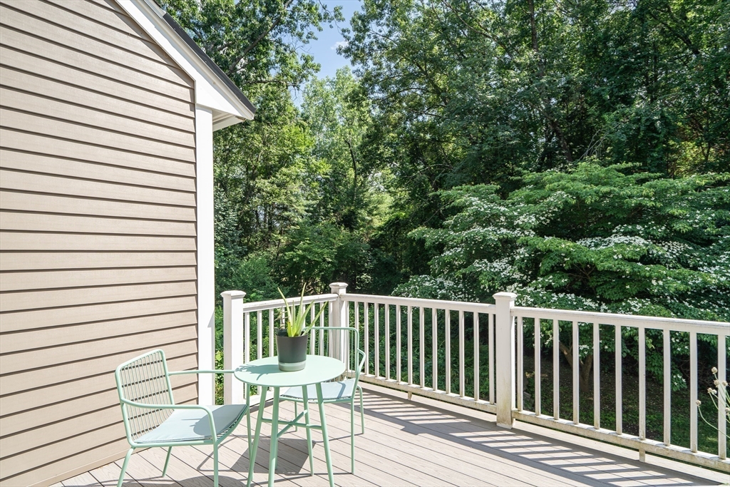 58 MacIntosh Lane, Unit 58 Boxborough, MA 01719 - Photo 22 of 23 a view of a chair and table in the balcony