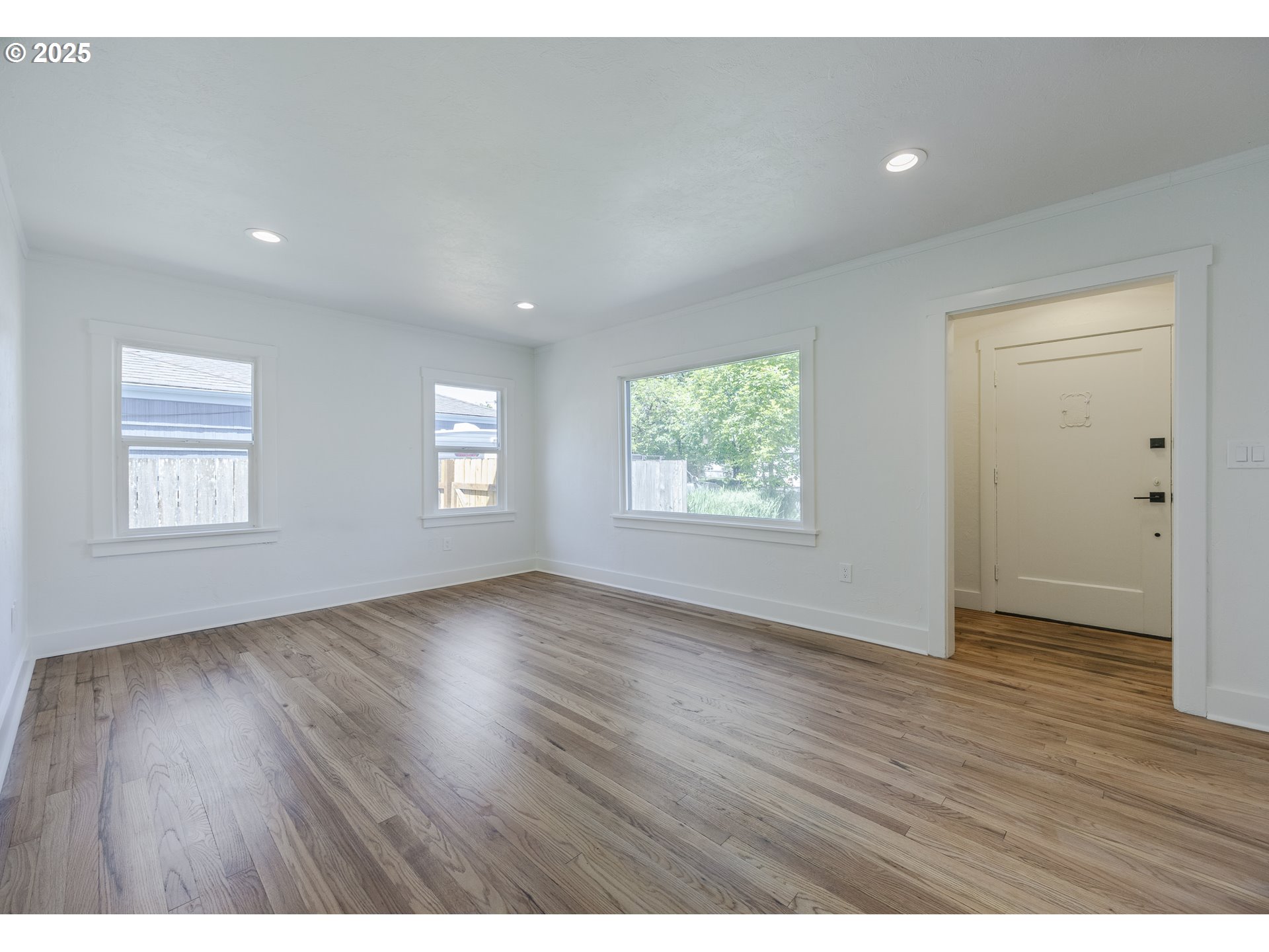 155 B Street Springfield, OR 97477 - Photo 11 of 42 an empty room with wooden floor and windows