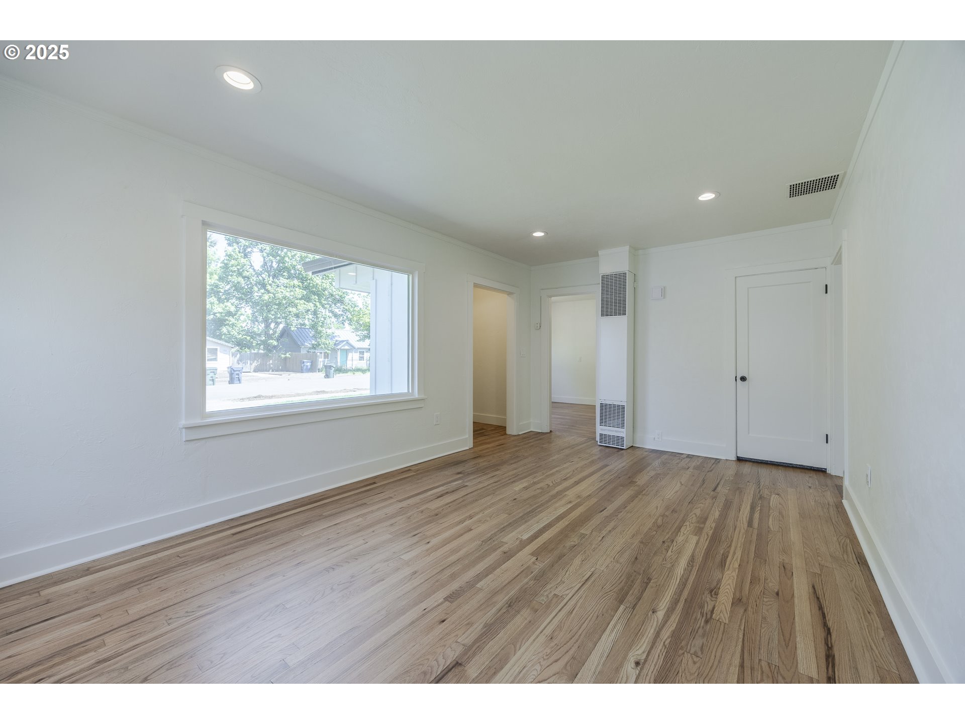 155 B Street Springfield, OR 97477 - Photo 12 of 42 an empty room with wooden floor and windows