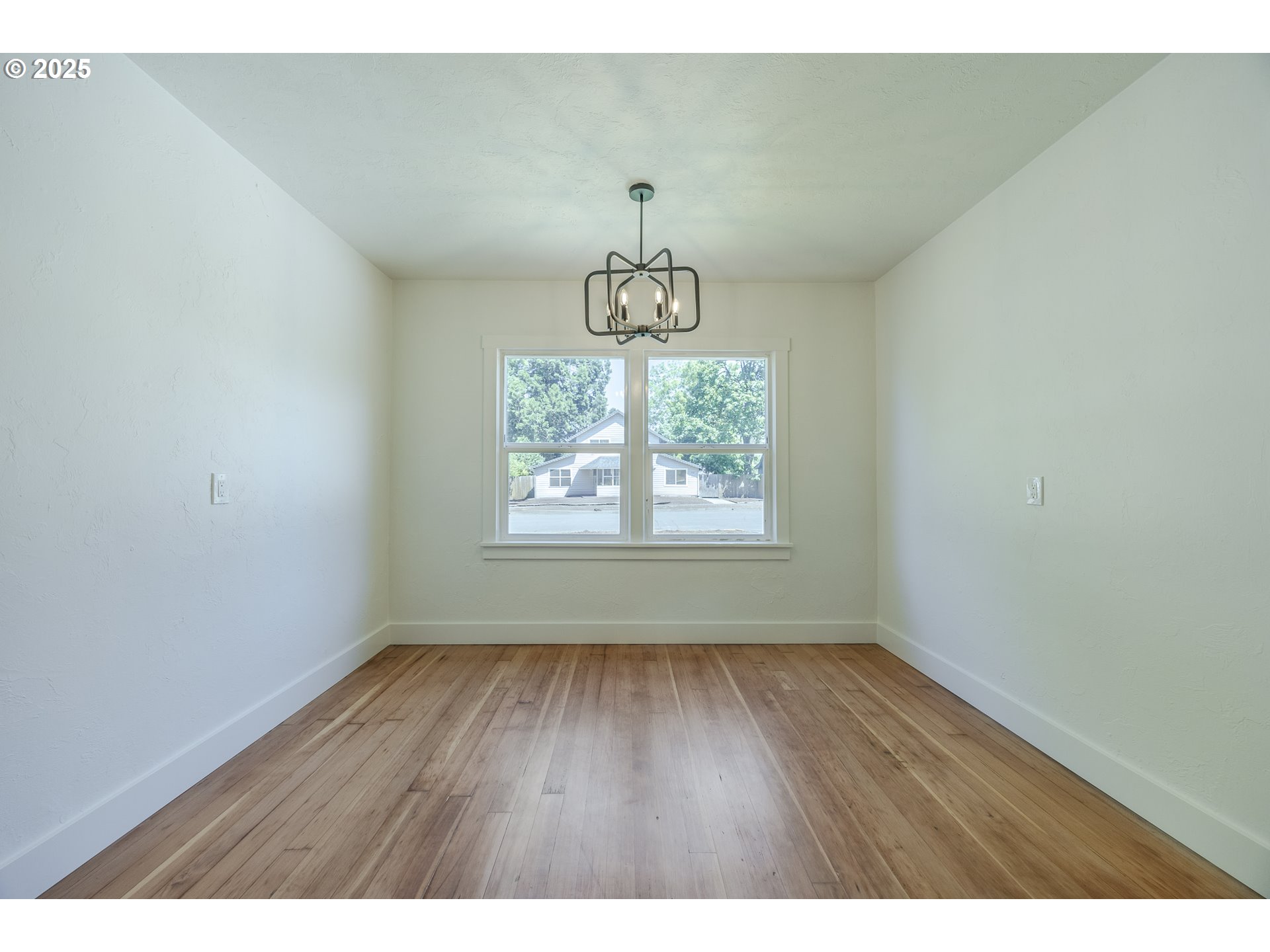 155 B Street Springfield, OR 97477 - Photo 13 of 42 a view of an empty room with wooden floor and a window