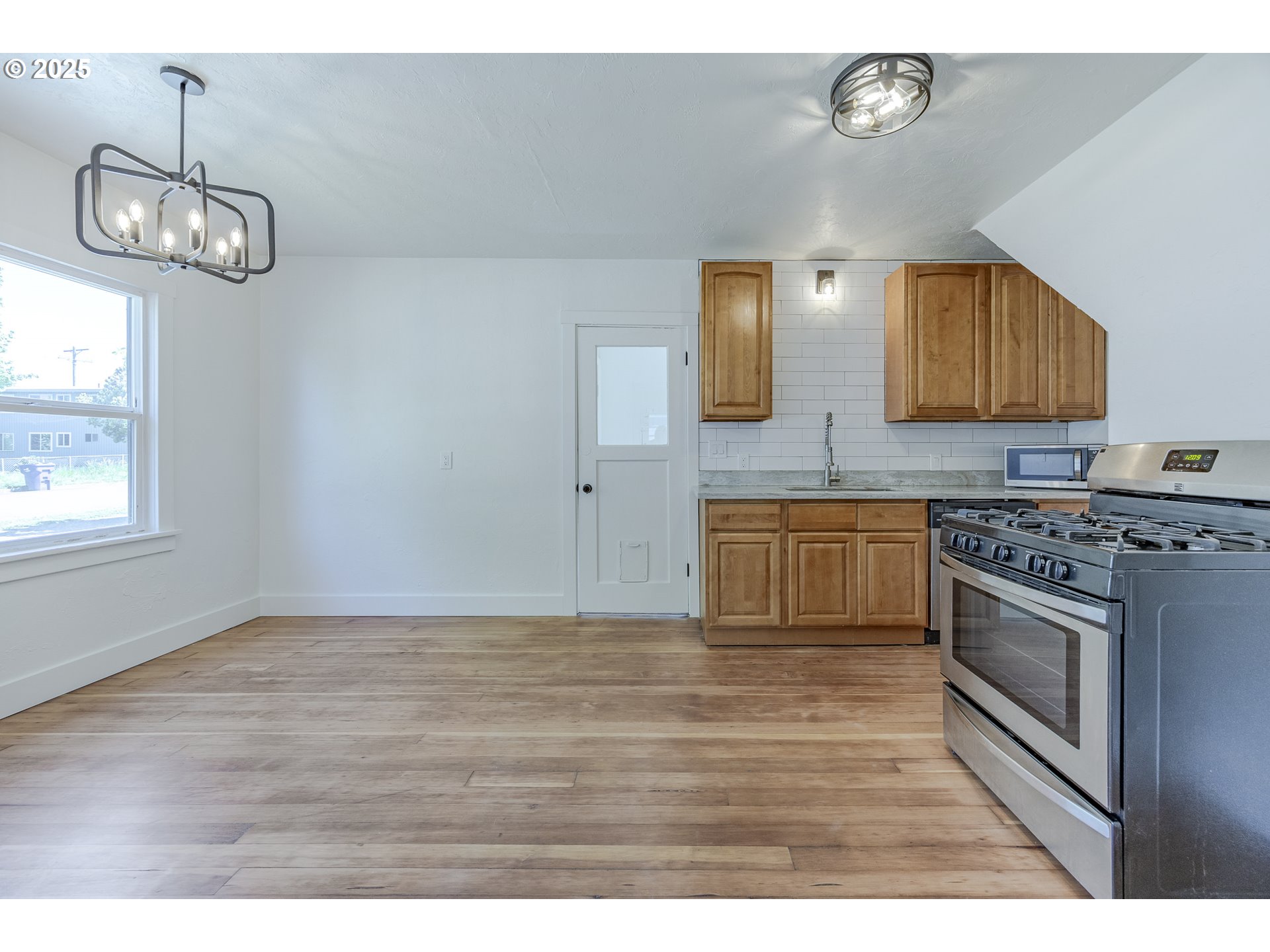 155 B Street Springfield, OR 97477 - Photo 15 of 42 a kitchen with a stove and a wooden floor