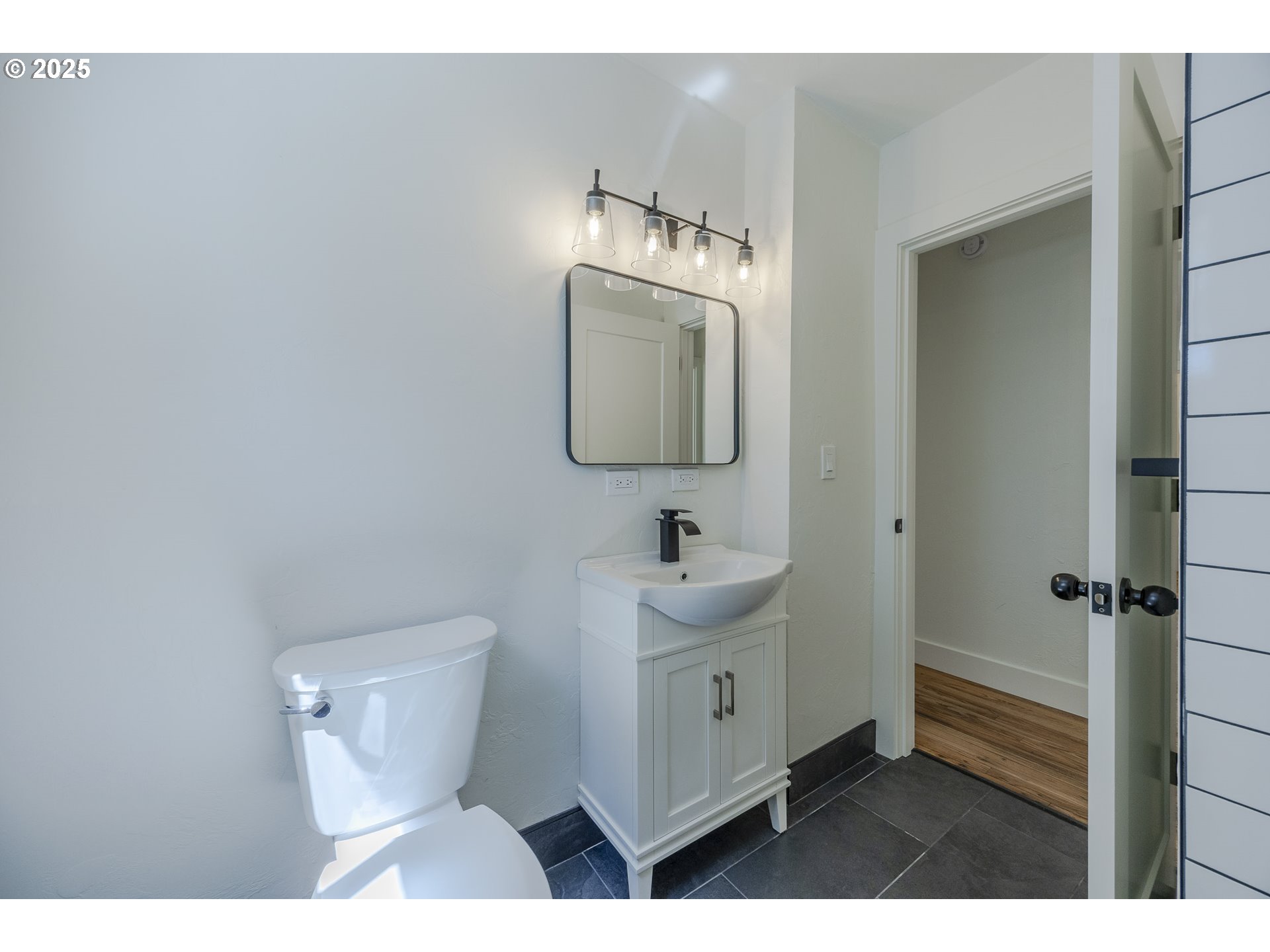 155 B Street Springfield, OR 97477 - Photo 26 of 42 a bathroom with a toilet a sink and mirror