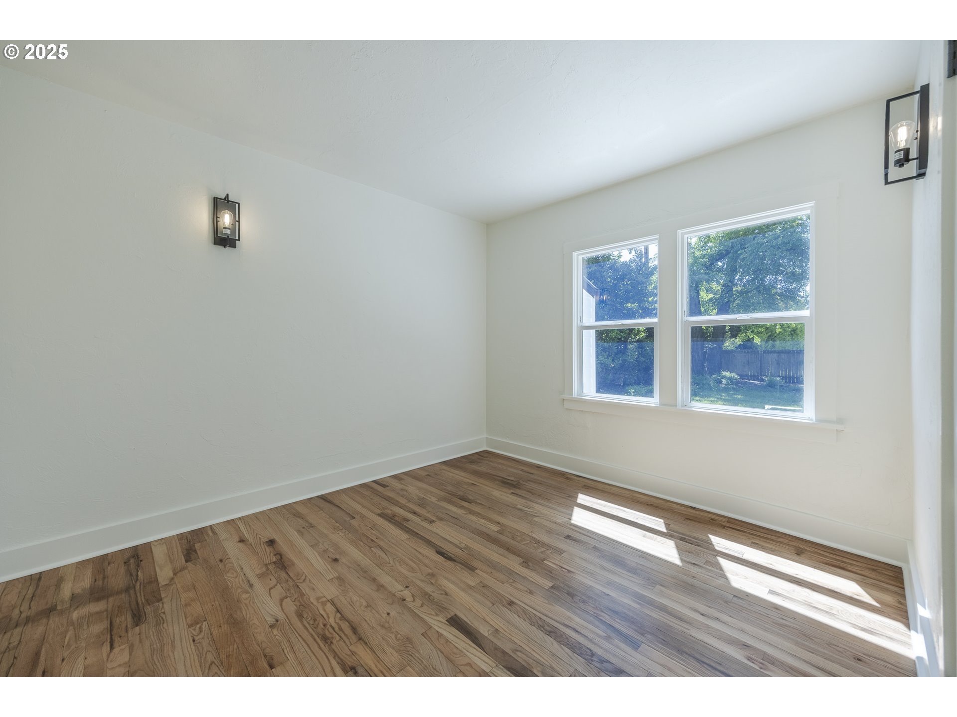 155 B Street Springfield, OR 97477 - Photo 28 of 42 a view of an empty room with wooden floor and a window