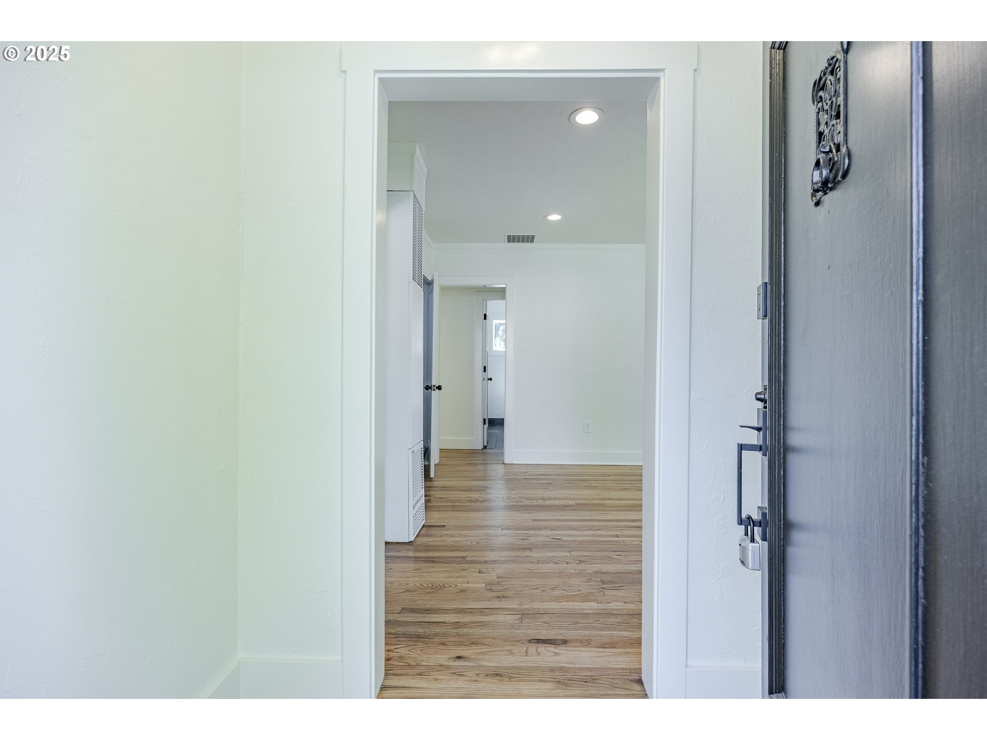 155 B Street Springfield, OR 97477 - Photo 5 of 42 a view of a hallway with wooden floor