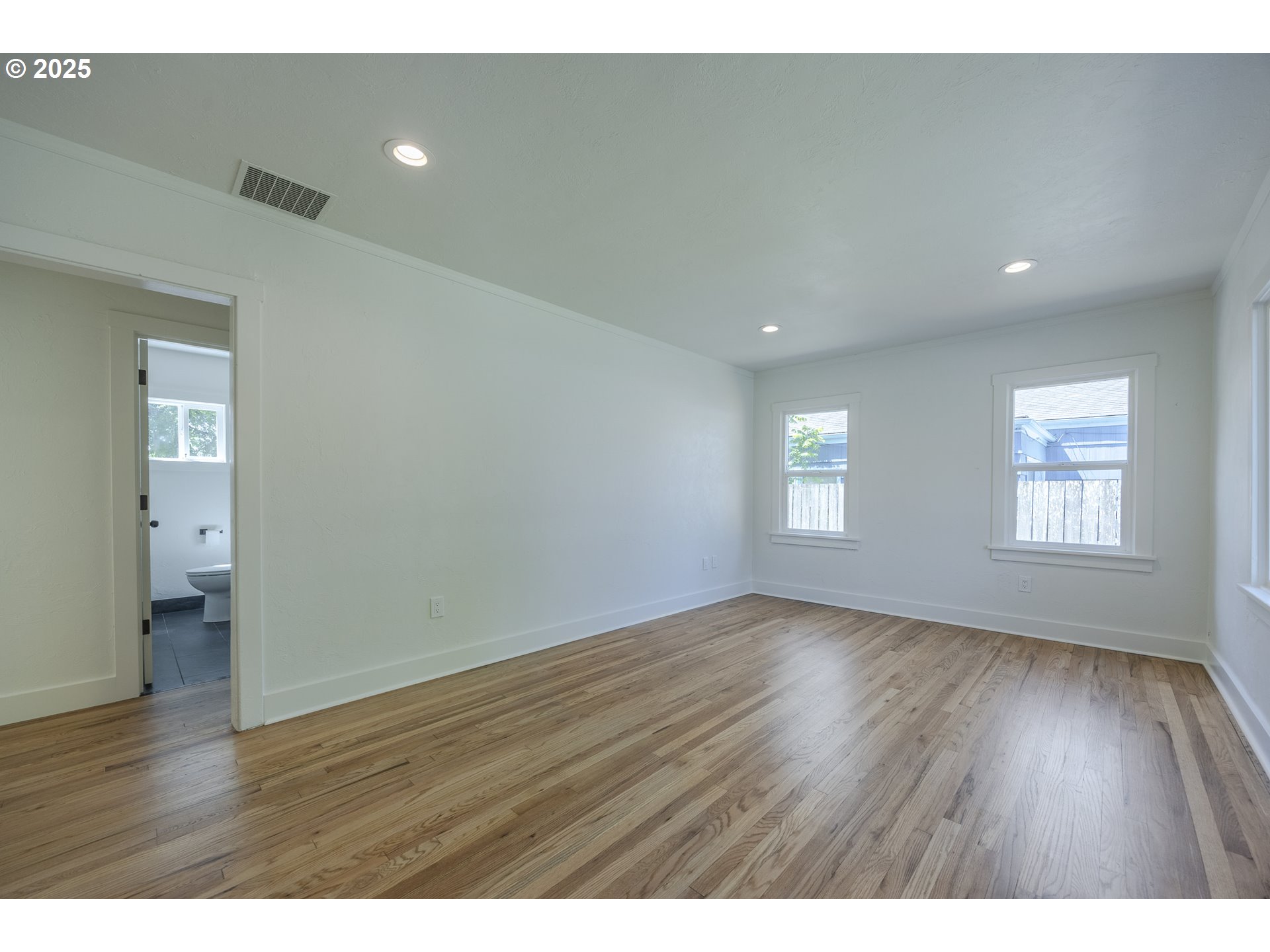 155 B Street Springfield, OR 97477 - Photo 10 of 42 a view of an empty room with wooden floor and a window