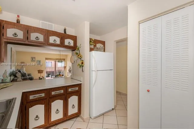 a kitchen with refrigerator and cabinets