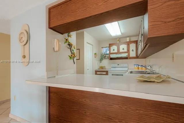 a view of a kitchen with a sink and wooden floor