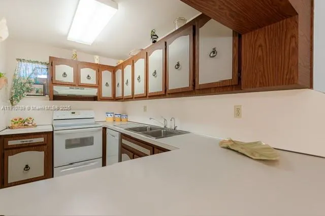 a kitchen with stainless steel appliances a stove a sink and a microwave
