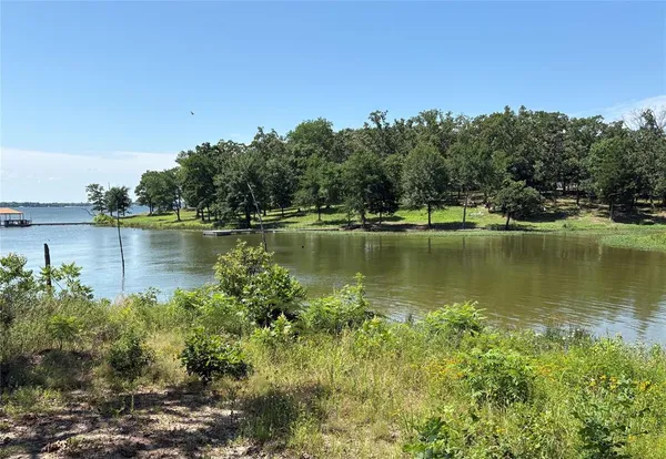 a view of a lake with houses in the back