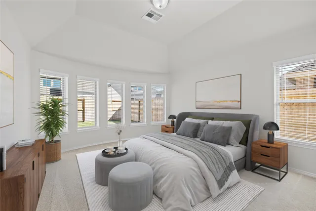 a bedroom with a large bed and a couch