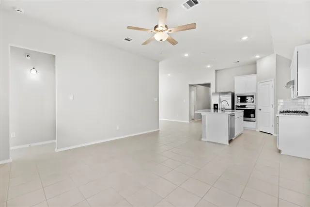 a view of kitchen with furniture and refrigerator