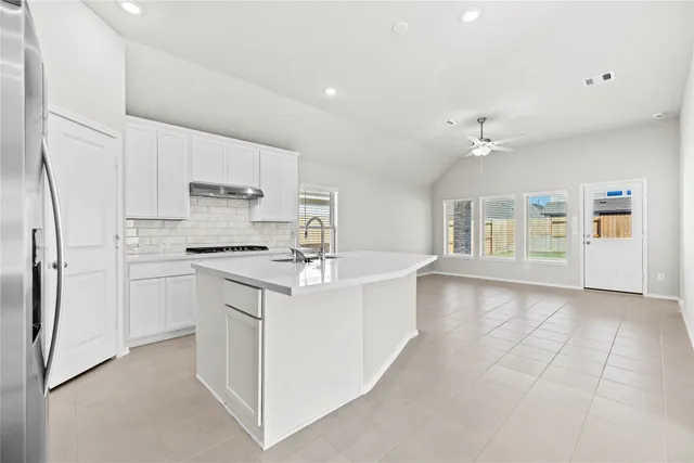 a kitchen with stainless steel appliances a refrigerator sink and cabinets