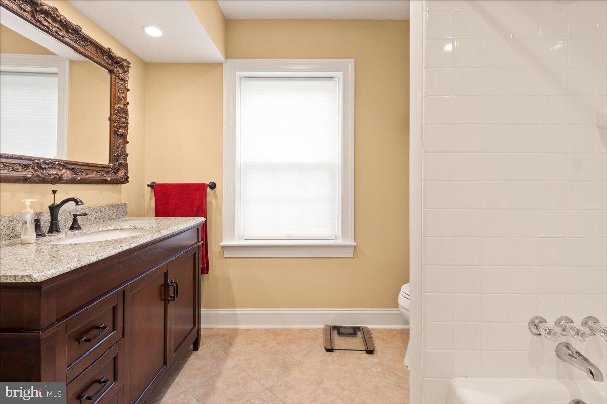 1214 Valley Road Villanova, PA 19085 - Photo 40 of 46 a bathroom with a granite countertop sink mirror and a bathtub