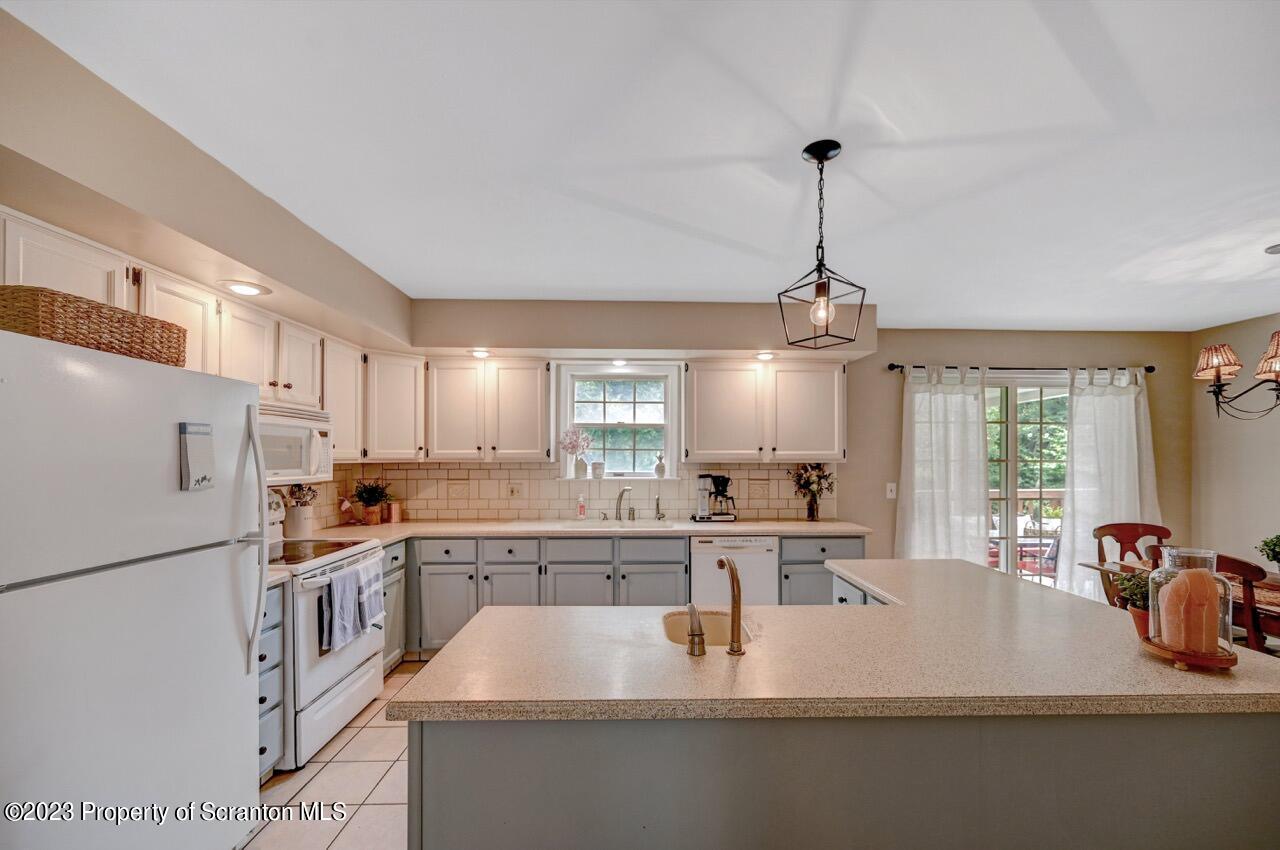 196 Elkview Drive Forest City, PA 18421 - Photo 25 of 67 a kitchen with stainless steel appliances granite countertop a sink a stove and a refrigerator