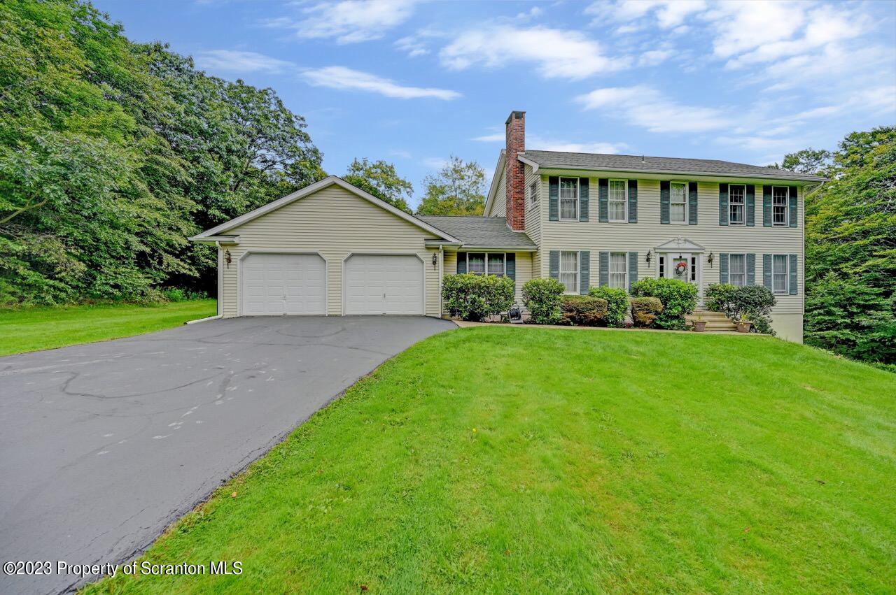 196 Elkview Drive Forest City, PA 18421 - Photo 3 of 67 a front view of a house with a garden and plants