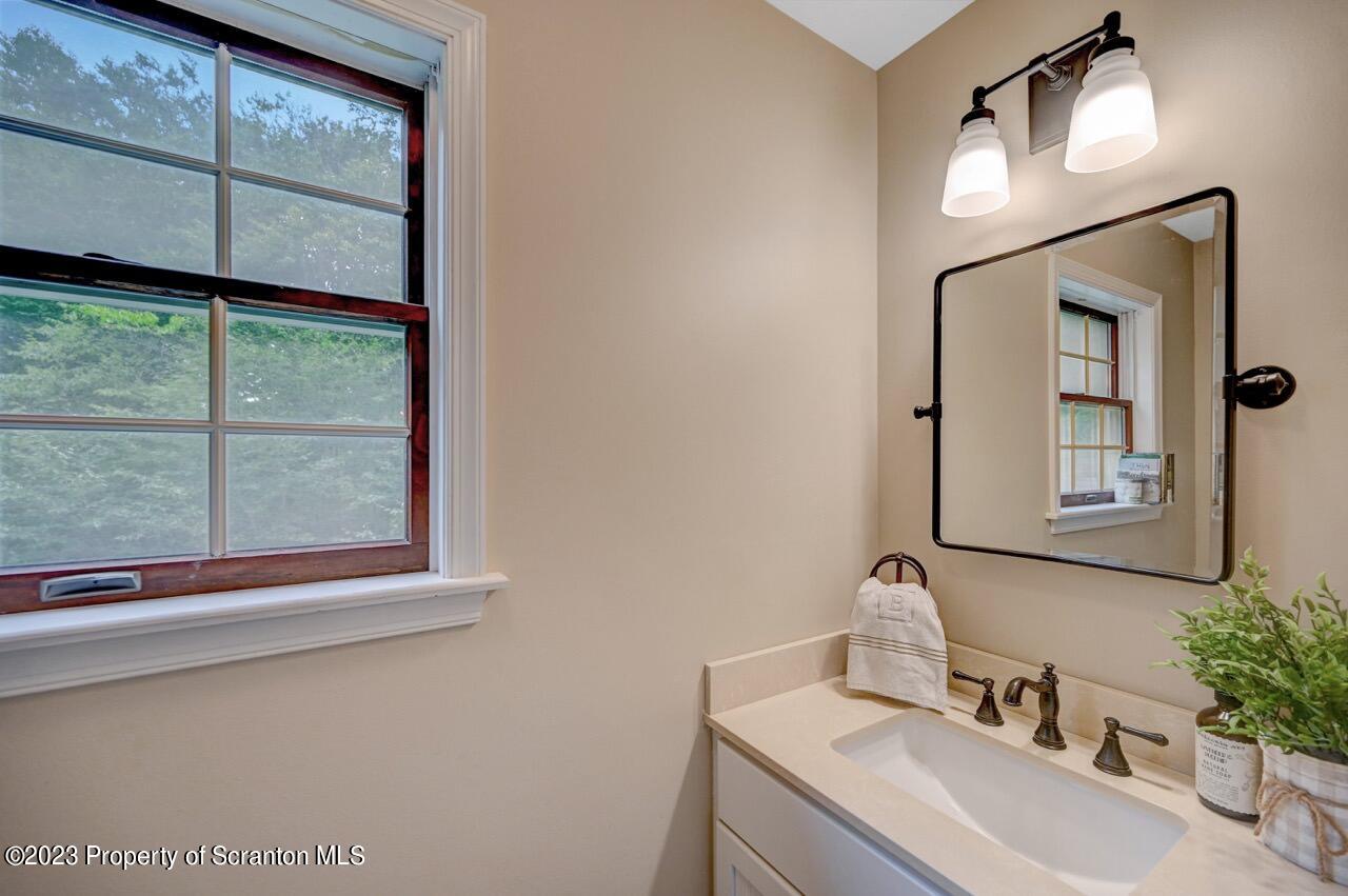 196 Elkview Drive Forest City, PA 18421 - Photo 31 of 67 a bathroom with a sink vanity and a mirror
