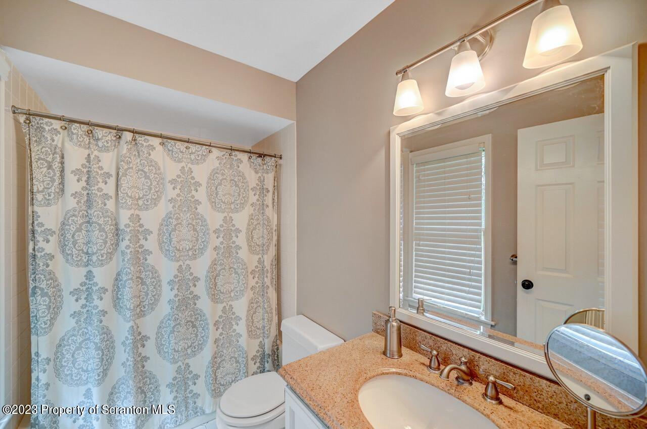 196 Elkview Drive Forest City, PA 18421 - Photo 38 of 67 a bathroom with a granite countertop sink toilet and shower