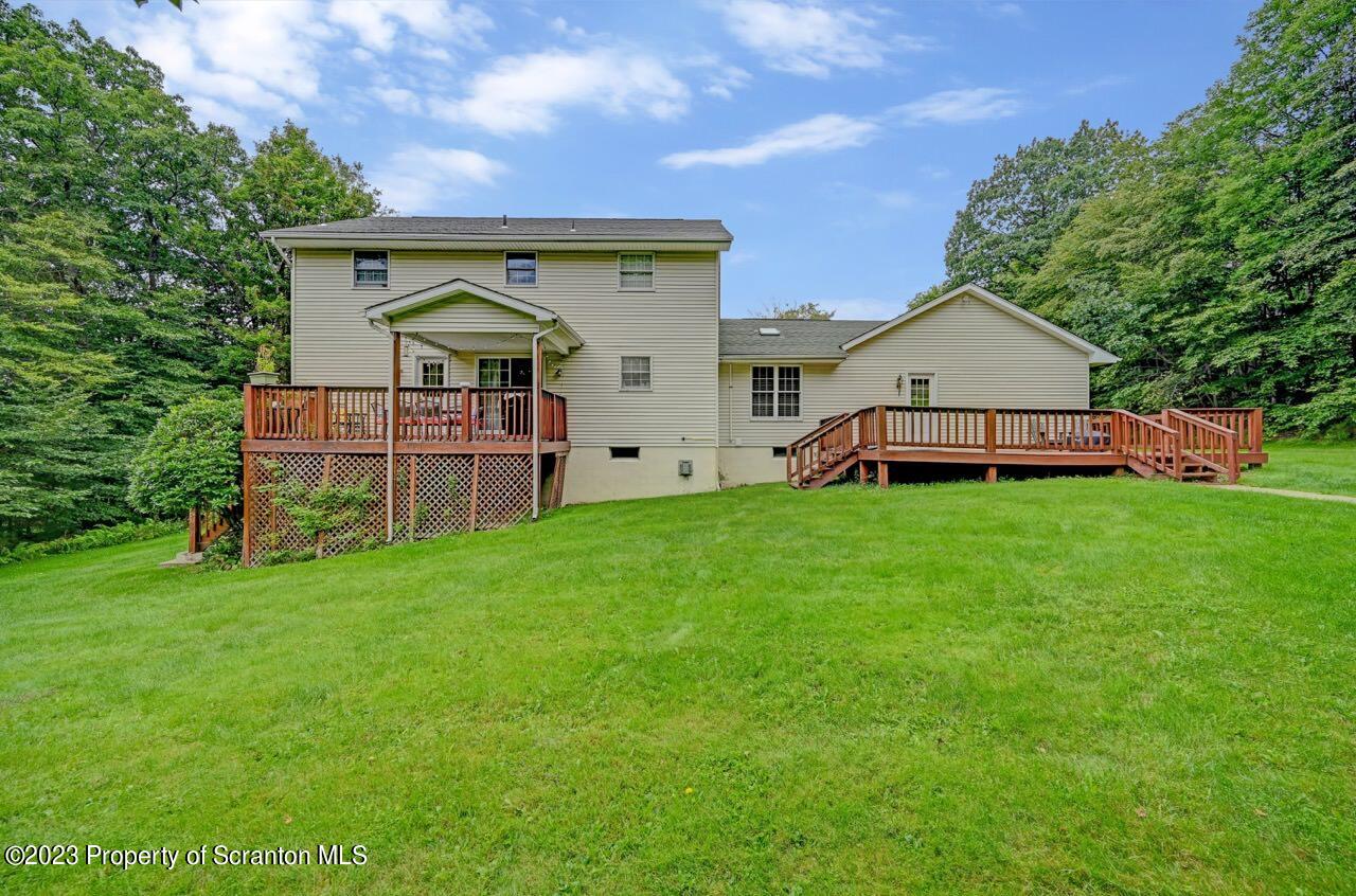 196 Elkview Drive Forest City, PA 18421 - Photo 5 of 67 a view of a house with a big yard and large tree