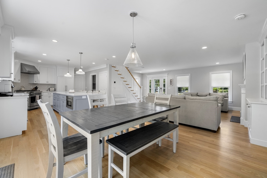 3 Bascom Hollow Harwich, MA 02645 - Photo 14 of 32 a kitchen with stainless steel appliances kitchen island a island a stove a table and chairs in it