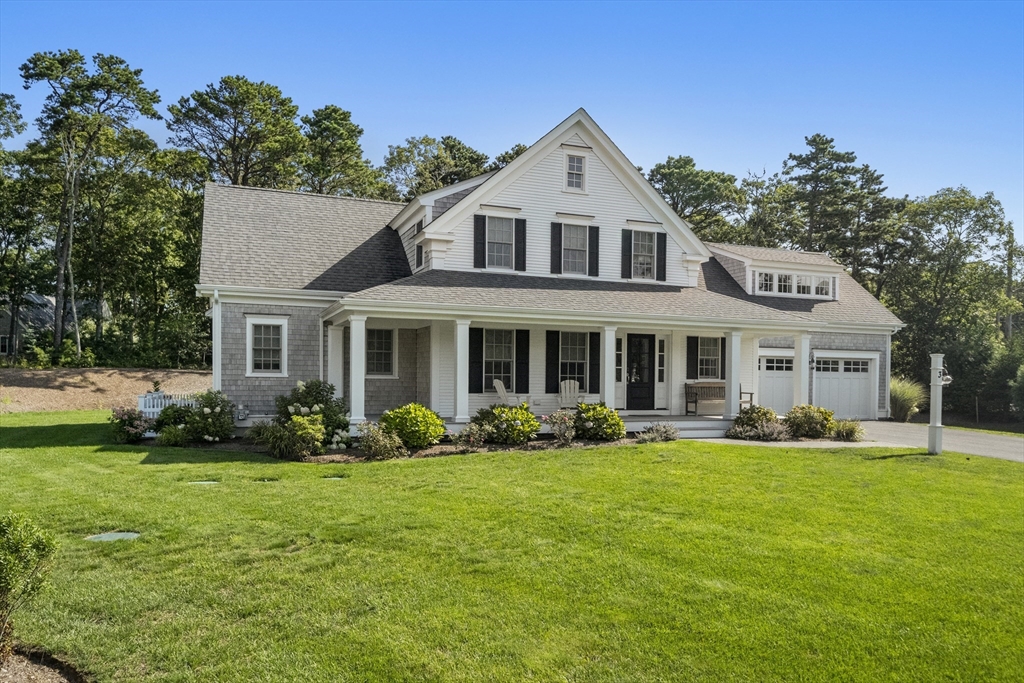 3 Bascom Hollow Harwich, MA 02645 - Photo 2 of 32 a front view of a house with a garden and trees